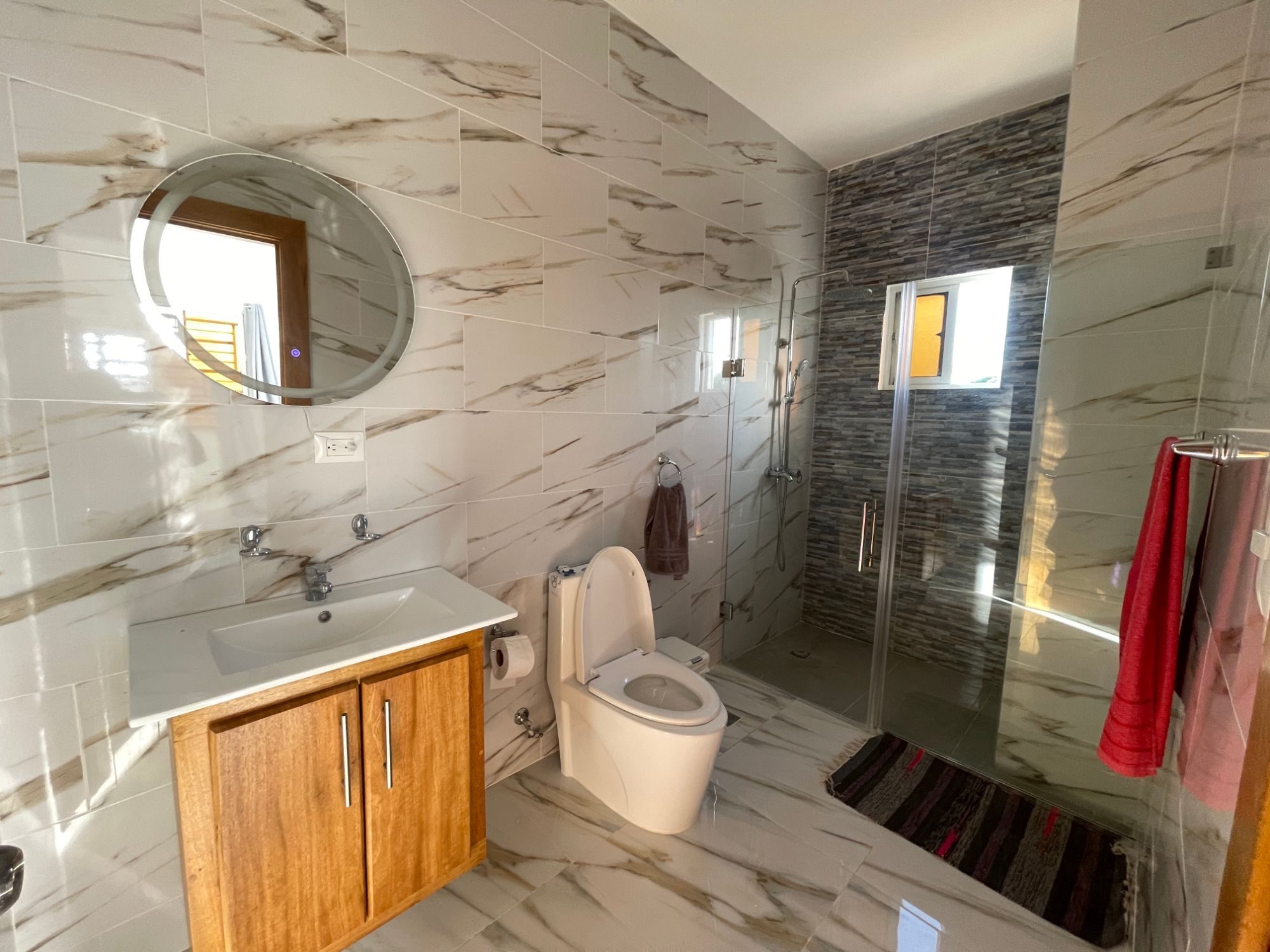 The second bathroom, with a glass shower enclosure