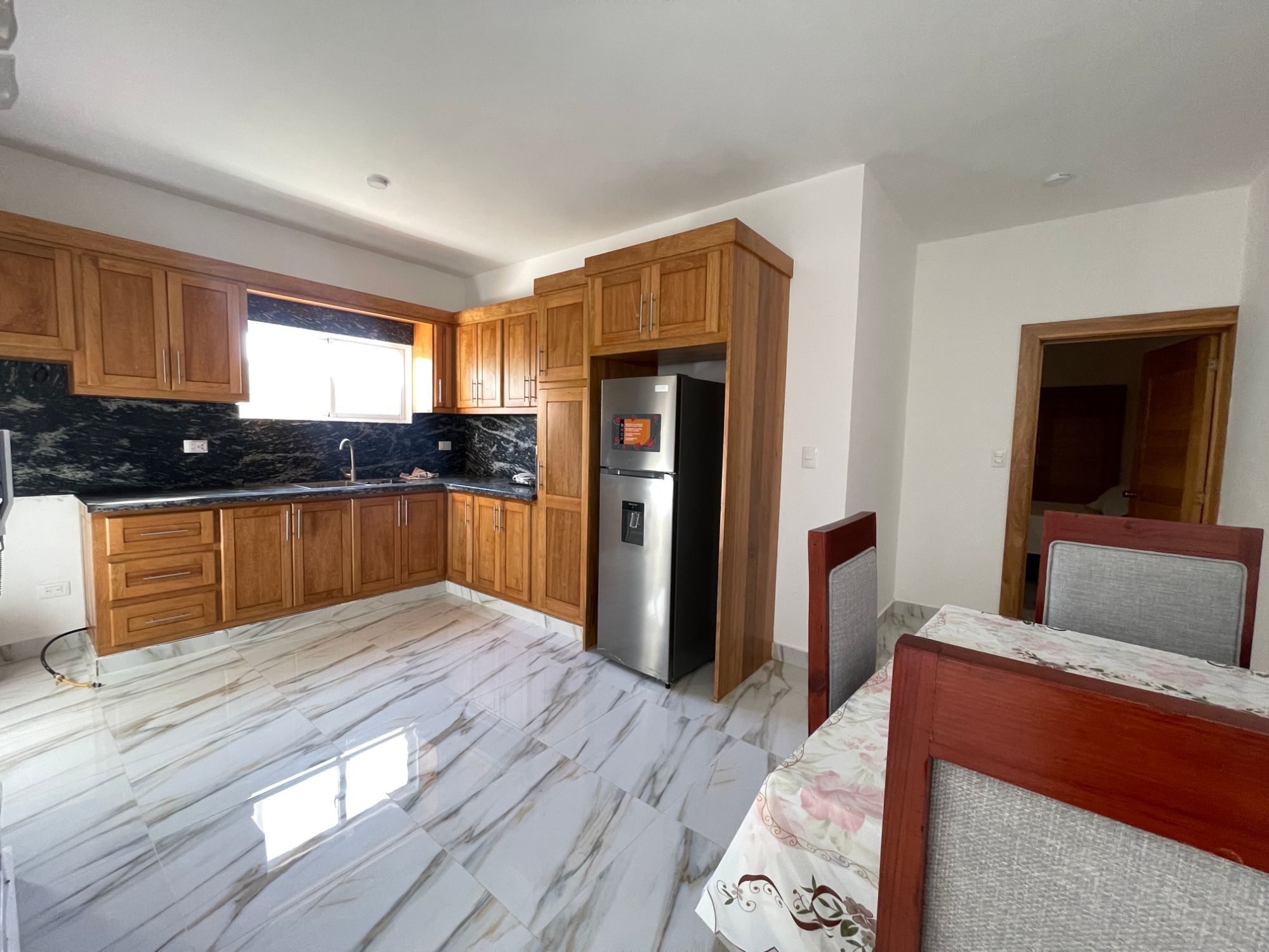 The kitchen, with wood cabinets and granite counters