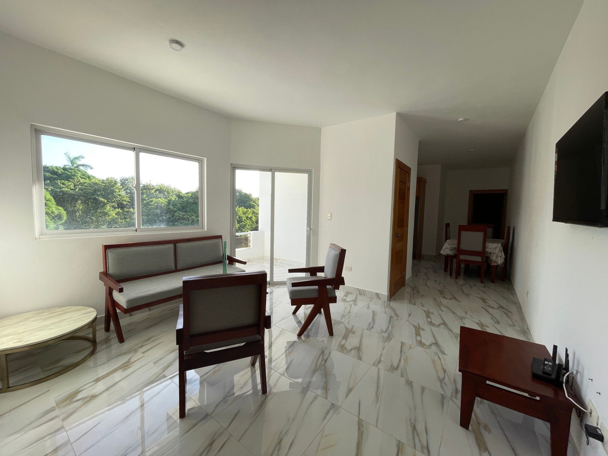 The living room of a two bathroom apartment, looking through to the terrace