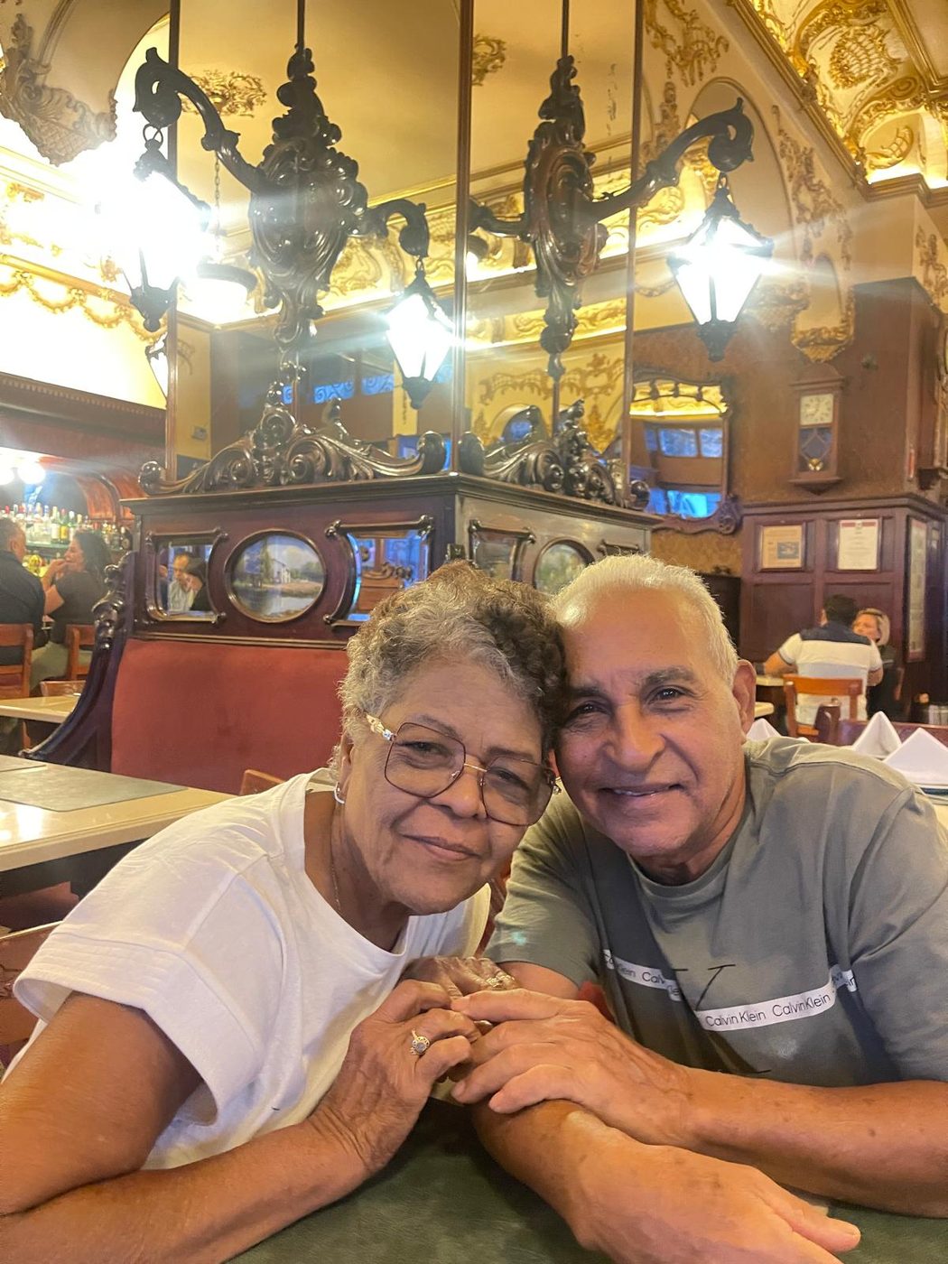 Elsa and Florencio, the owners of Las Tres Casitas, sitting together at a restaurant table in Puerto Plata