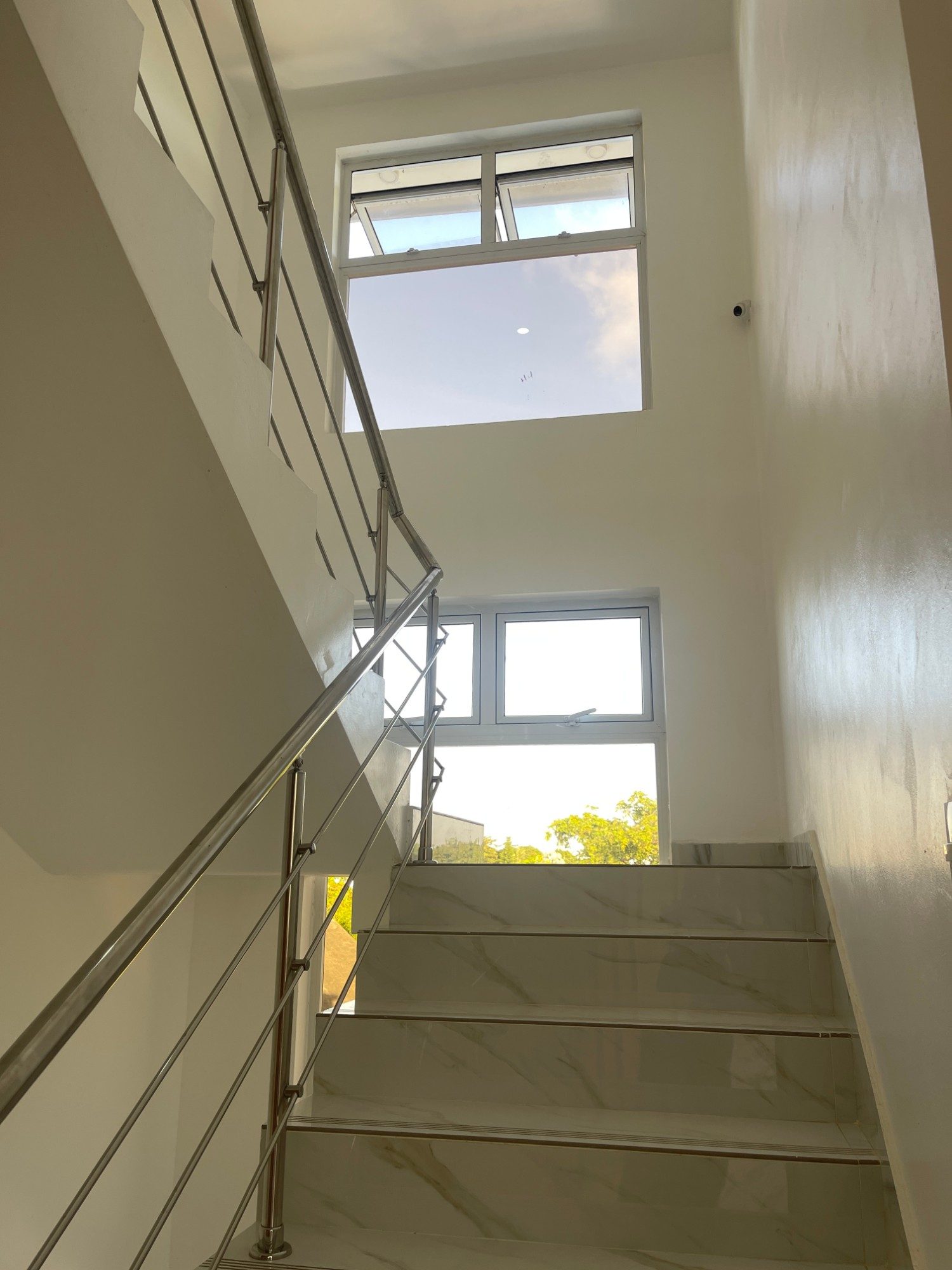 The stairs up to the apartments, with a camera on the wall
